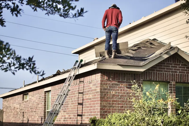 Professional roofer working on a residential roof in Wallace Mill